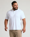 Man modeling Premium Pima Polo 7-Pack, showcasing white polo's tailored fit.