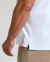 White Premium Pima Polo with tailored fit, side slit hem visible.