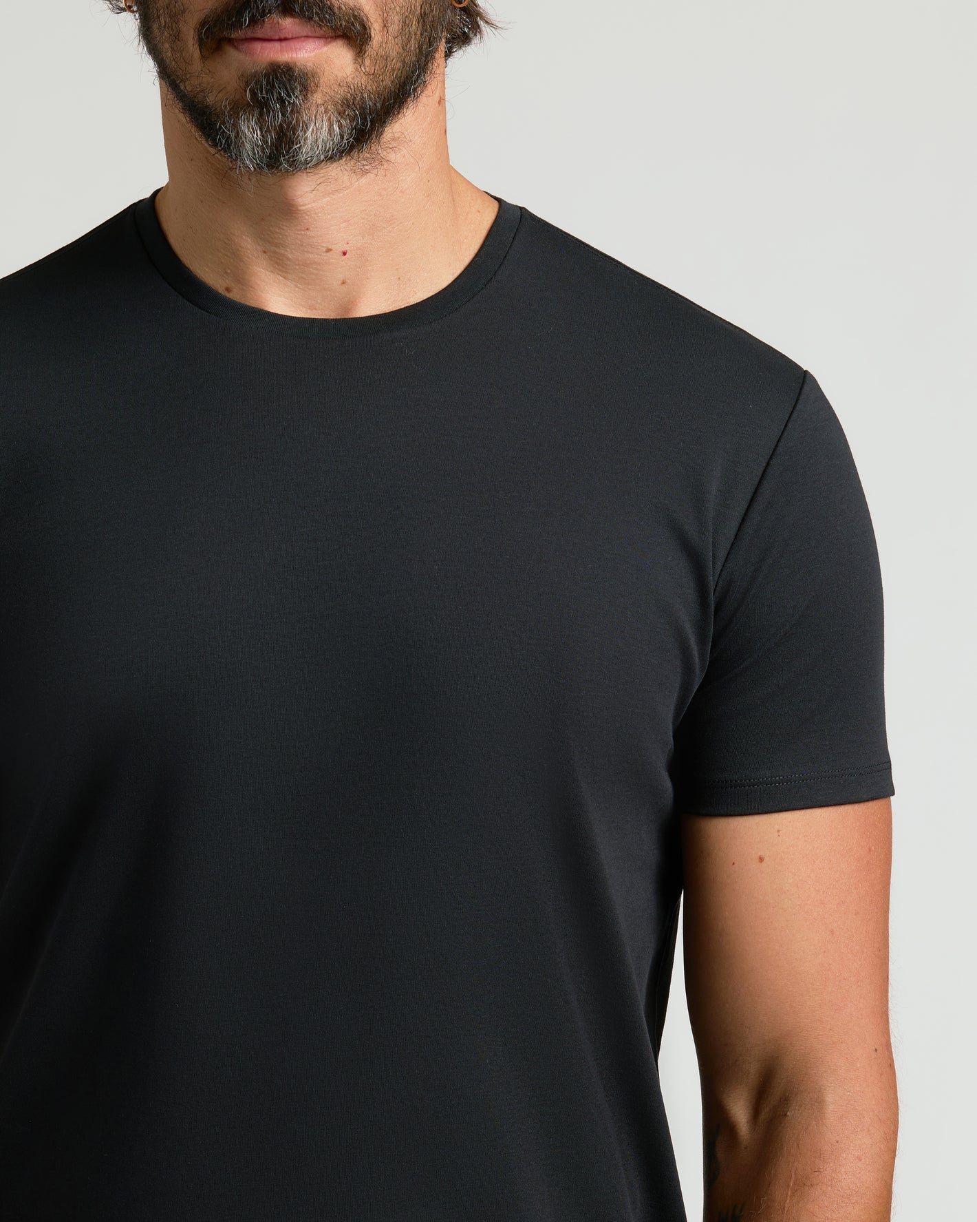 Man wearing Black Premium Pima Crew Curved Hem Tee.