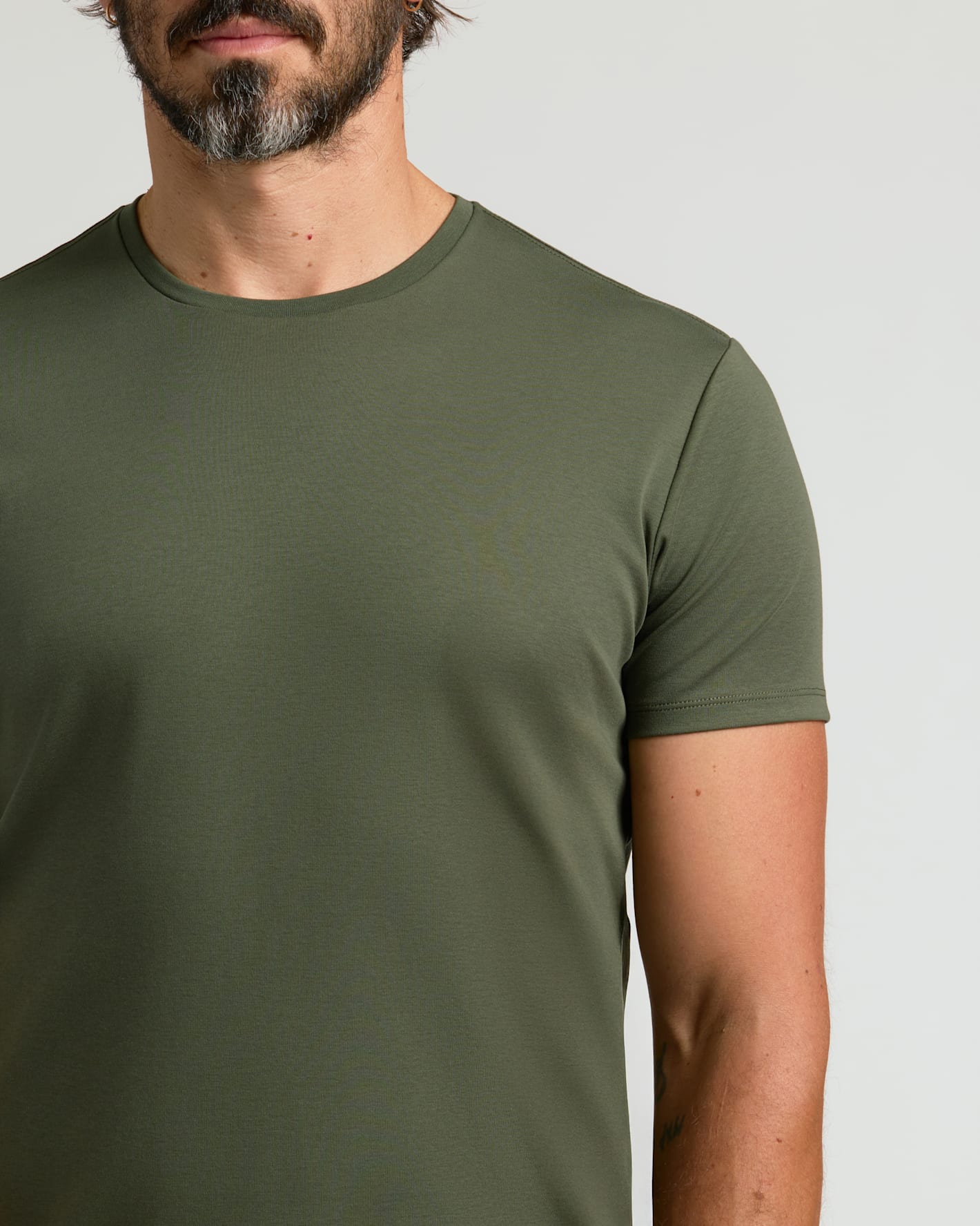 Man wearing All Grove Pima Cotton Blend Curved Hem Crew T-shirt.