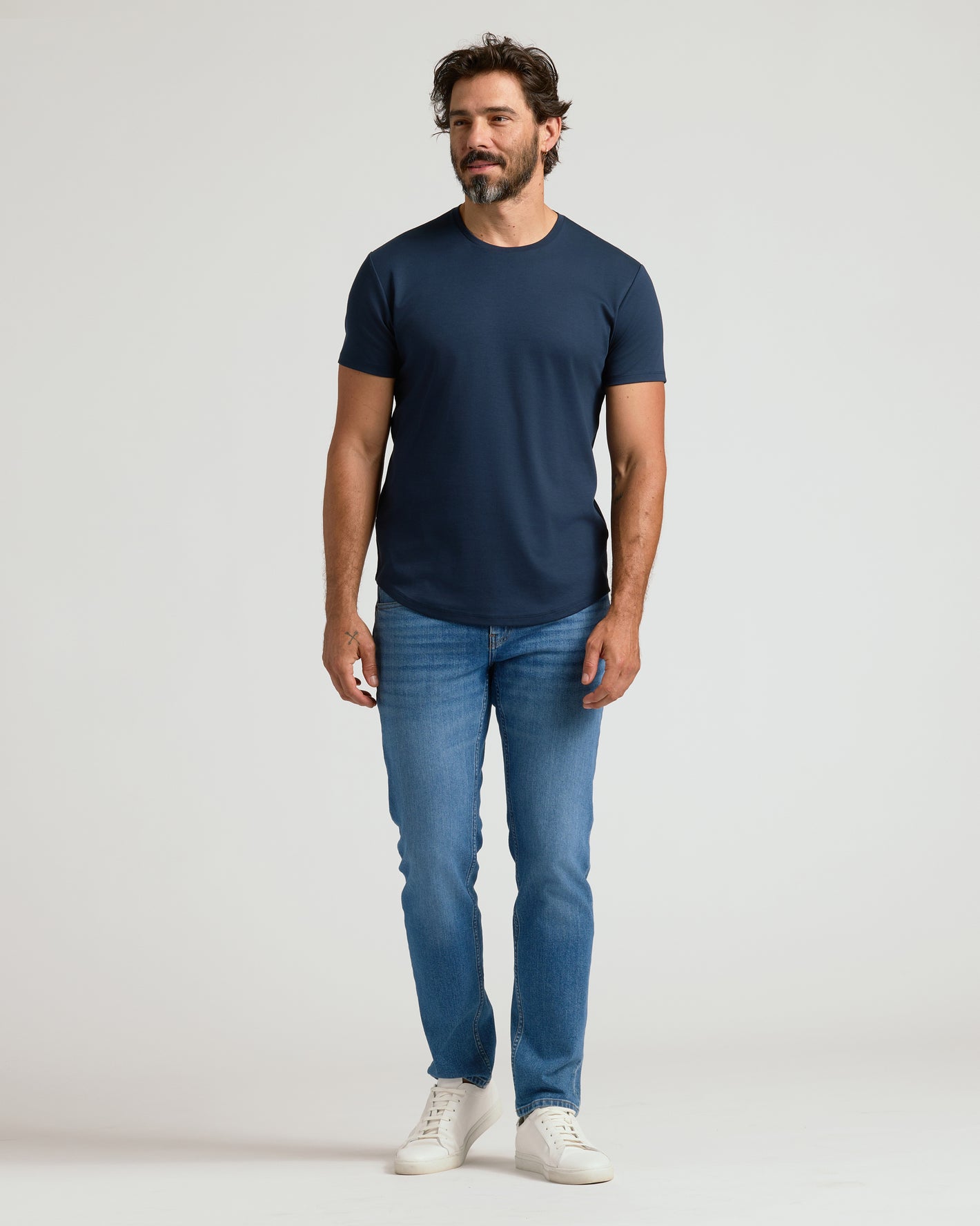 Navy Premium Pima Crew Curved Hem T-shirt on man, showcasing tailored fit.