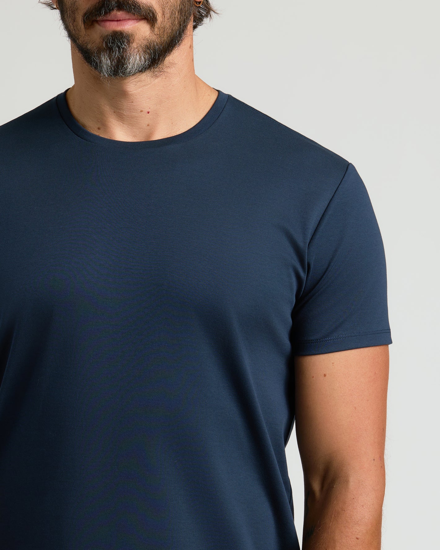 Navy Premium Pima Crew Curved Hem on man, showing tailored fit.