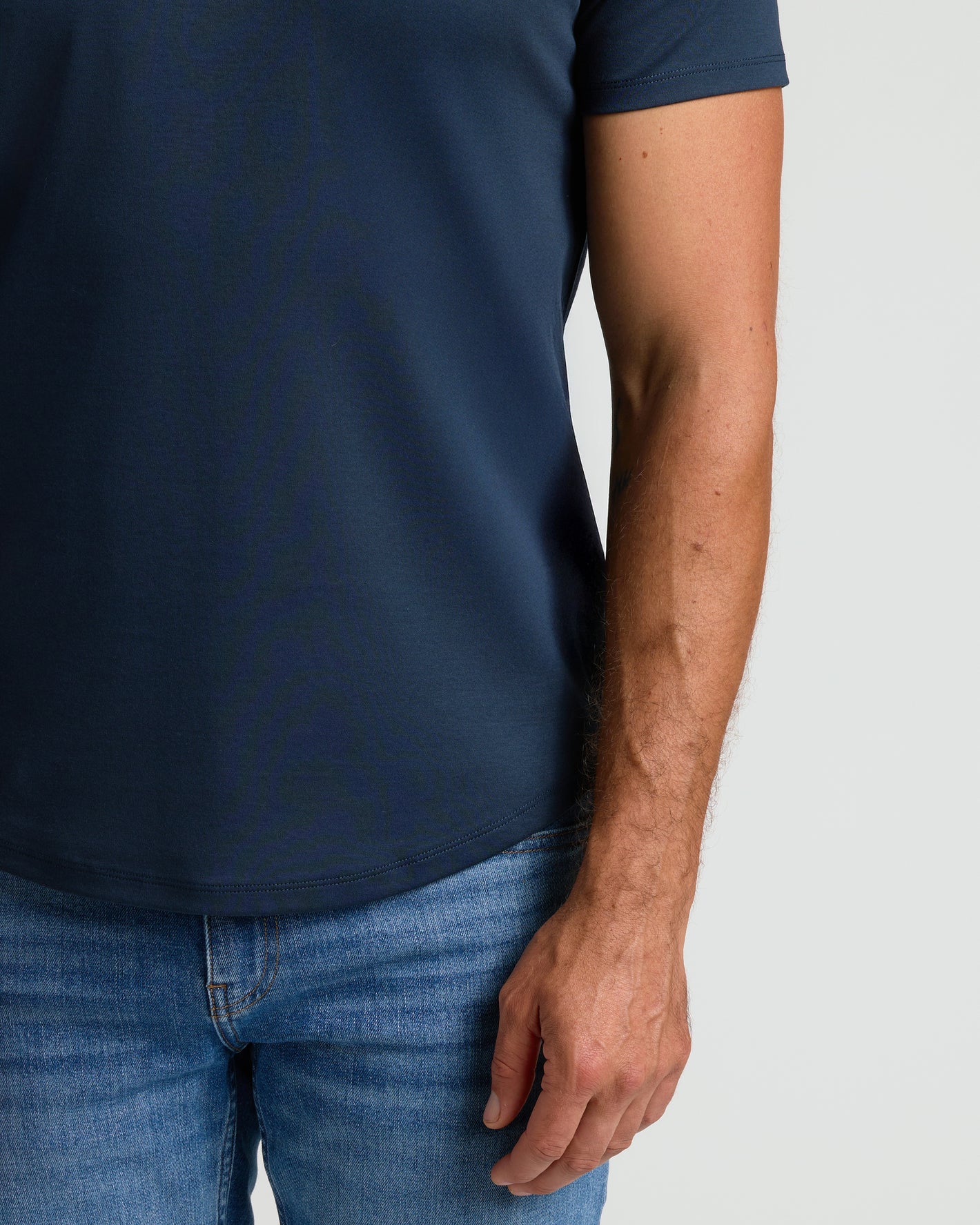 Navy Premium Pima Crew Curved Hem T-shirt with medium-wash jeans.