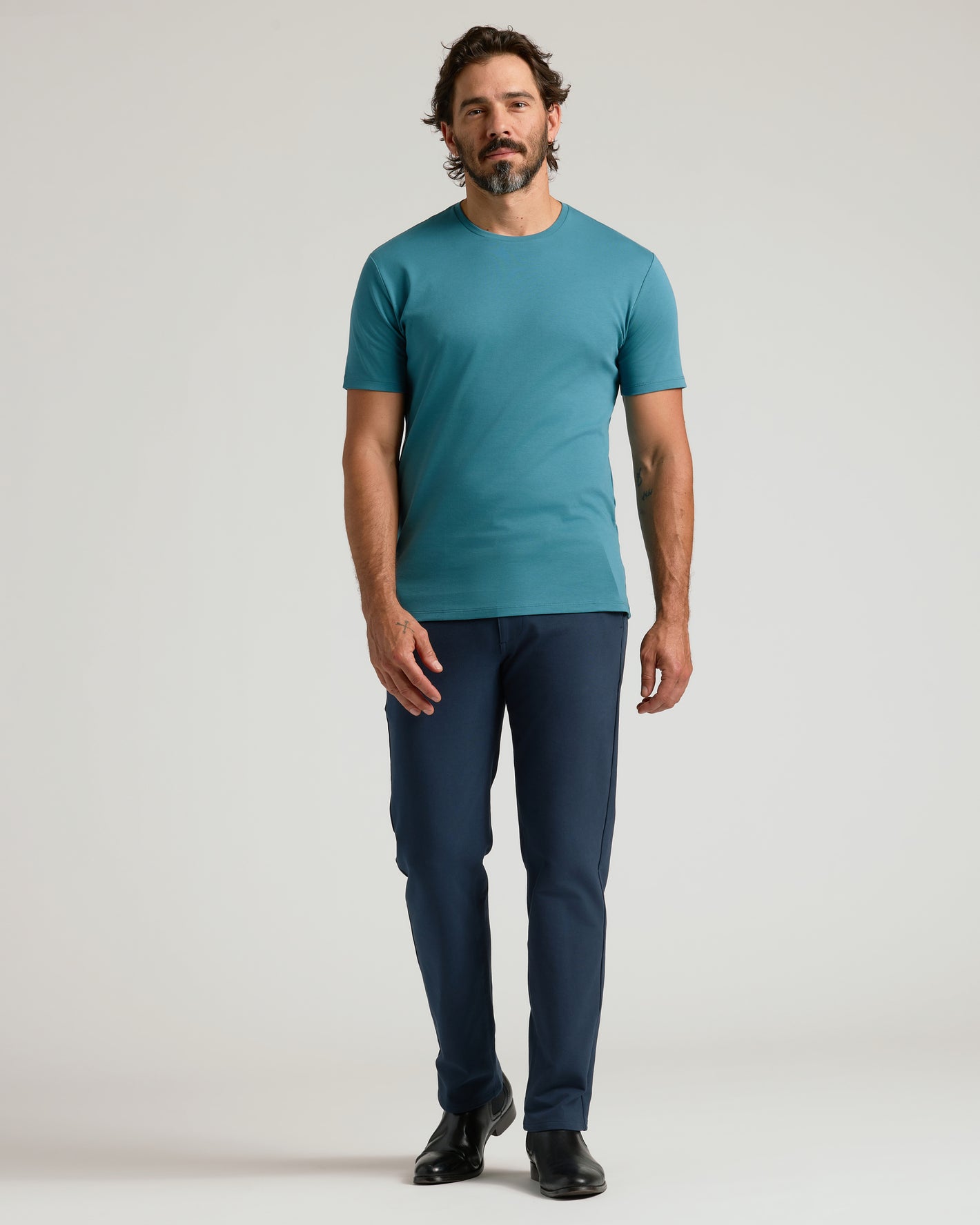 Sapphire Premium Pima Crew Neck on man with tattoos, navy pants.