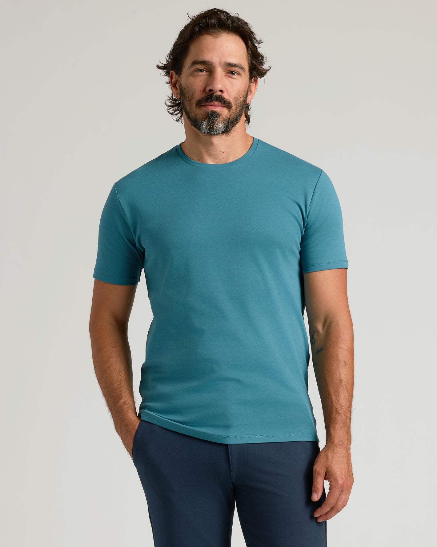 Man wearing Sapphire Premium Pima Crew Neck and navy pants.