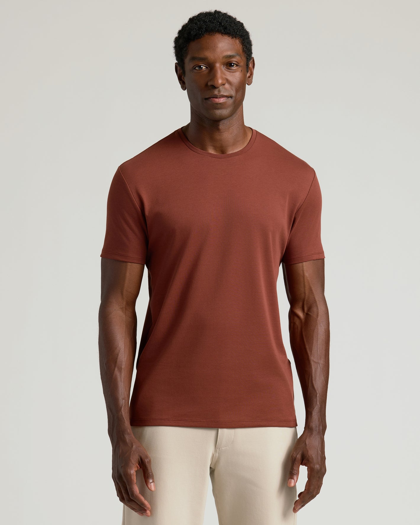 Man wearing Chestnut Premium Pima Crew Neck T-shirt, minimalist style.