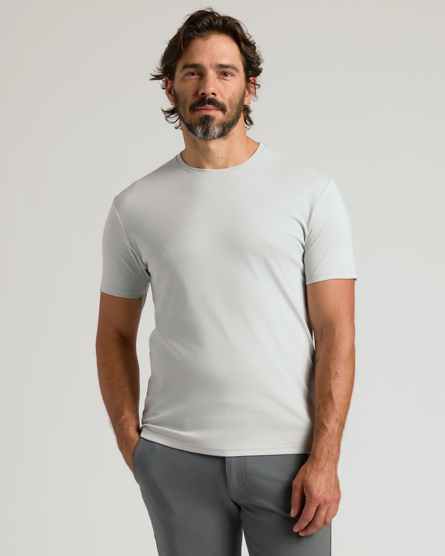 Man wearing Vapor Premium Pima Crew Neck in light gray, relaxed stance.