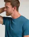 Man wearing Lagoon Premium Pima Crew Neck T-shirt, side view.