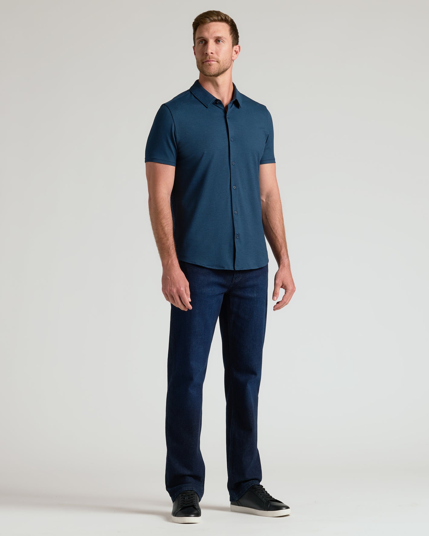 Man in Dark Heather Navy Short Sleeve Comfort Knit Shirt.