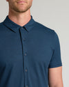 Man wearing Dark Heather Navy Short Sleeve Comfort Knit Shirt, showcasing its button-front design.