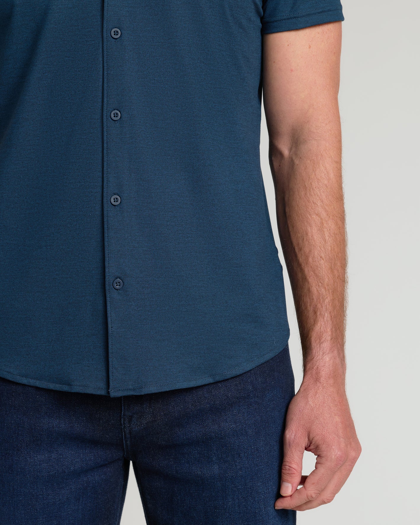 Man in Dark Heather Navy Short Sleeve Comfort Knit Shirt with jeans.