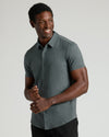 Charcoal Heather Gray Short Sleeve Comfort Knit Shirt modeled by a smiling man.