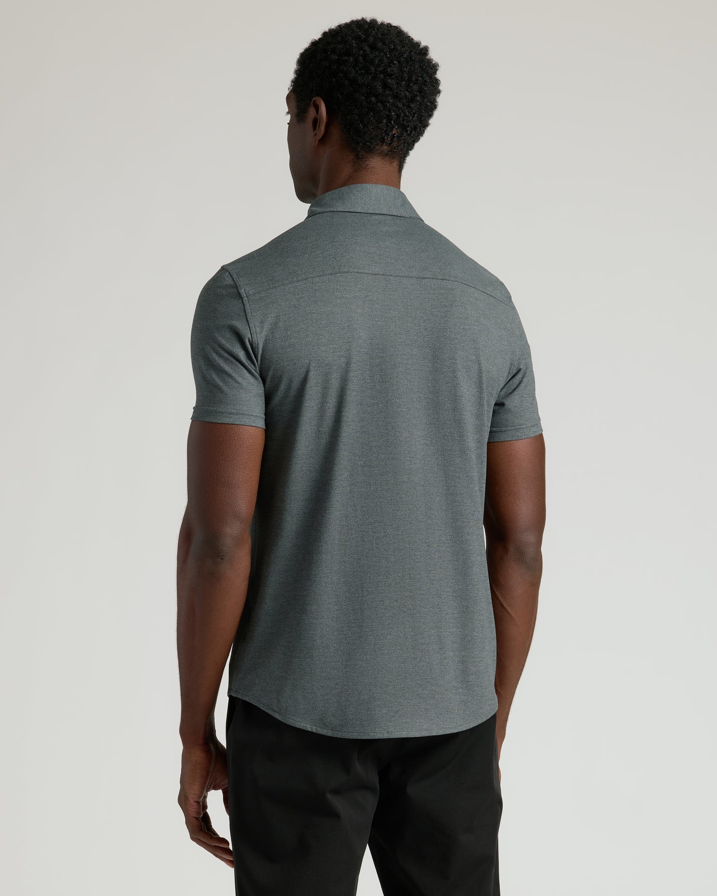 Back view of man in Charcoal Heather Gray Short Sleeve Comfort Knit Shirt.