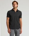 Man wearing Staple Short Sleeve Performance Dress Shirt, showcasing relaxed fit.