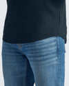 Close-up of blue jeans and a black shirt on a white background