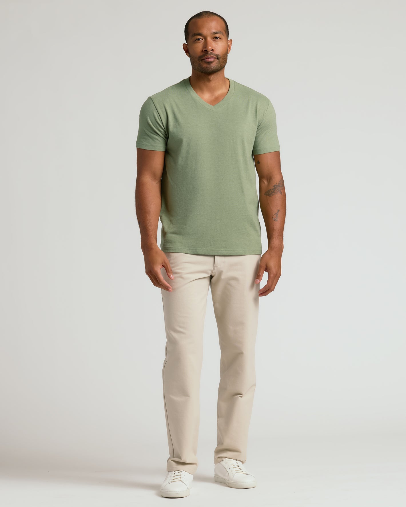 Man in Dark Heather Bay Green Classic V-Neck with beige trousers.