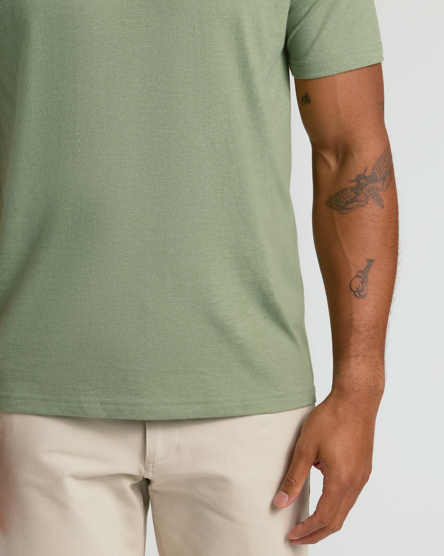 Dark Heather Bay Green Classic V-Neck on model with tattooed arm.