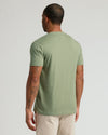 Man in Dark Heather Bay Green Classic V-Neck, showcasing tattoos.