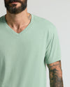 Heather Slate Green Classic V-Neck on a bearded man with tattoos.