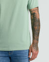 Heather Slate Green Classic V-Neck showcasing tattooed forearm.