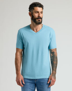 Heather Voyager Classic V-Neck on tattooed man with relaxed pose.