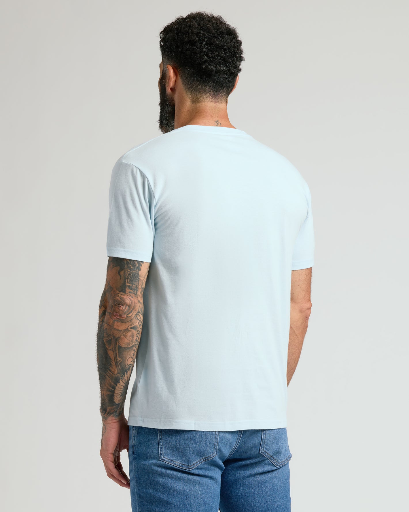 Man wearing Icicle Classic V-Neck showcasing tattooed arm.