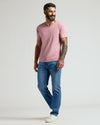 Man wearing a Light Heather Boysenberry Classic V-Neck, smiling casually.