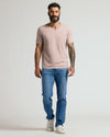 Man wearing Light Heather Slate Mauve Classic V-Neck, jeans, sneakers.