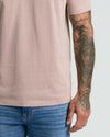 Light Heather Slate Mauve Classic V-Neck on tattooed arm with denim jeans.