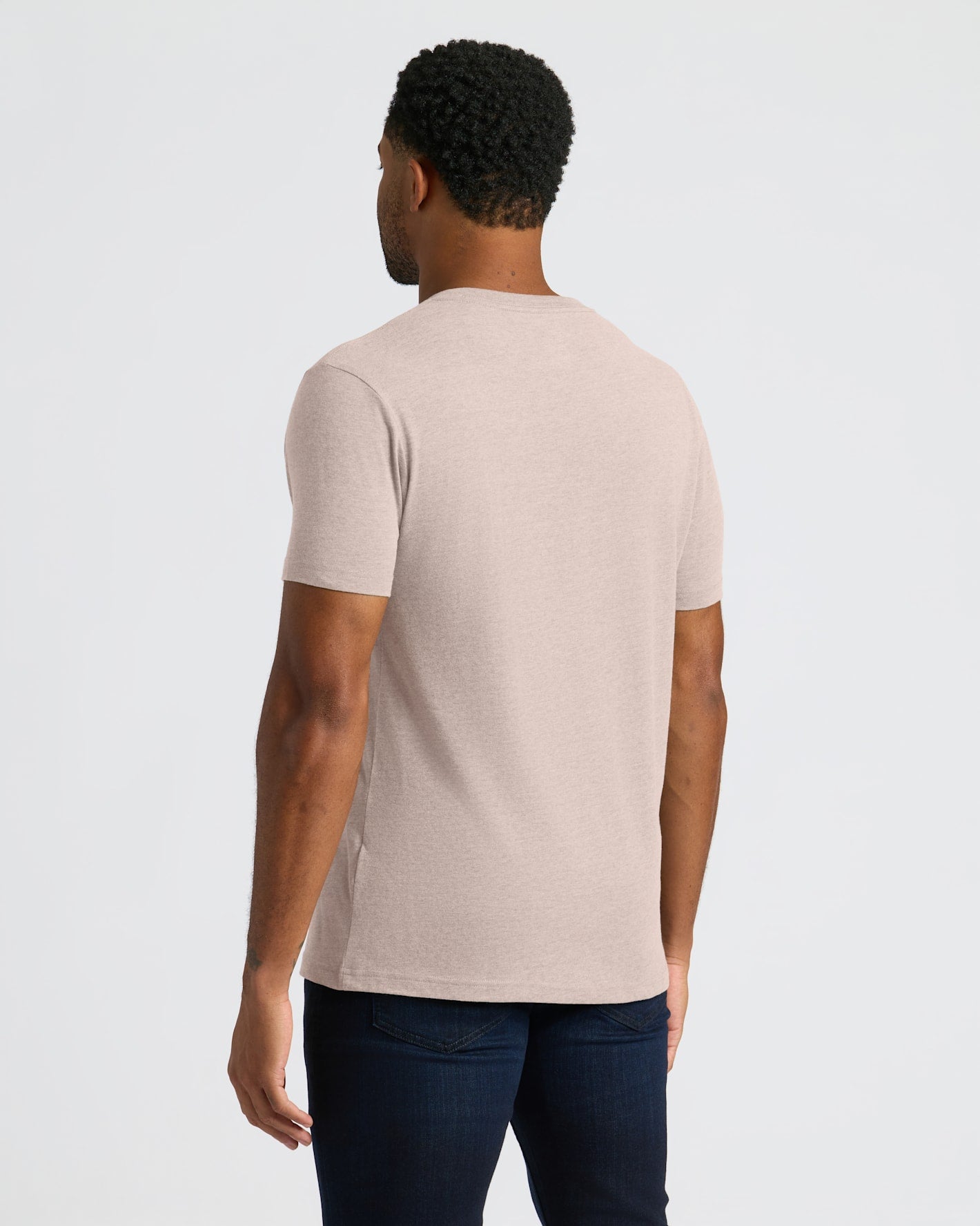 Man wearing a beige t-shirt on a white background