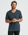 Man wearing a dark gray t-shirt on a light gray background