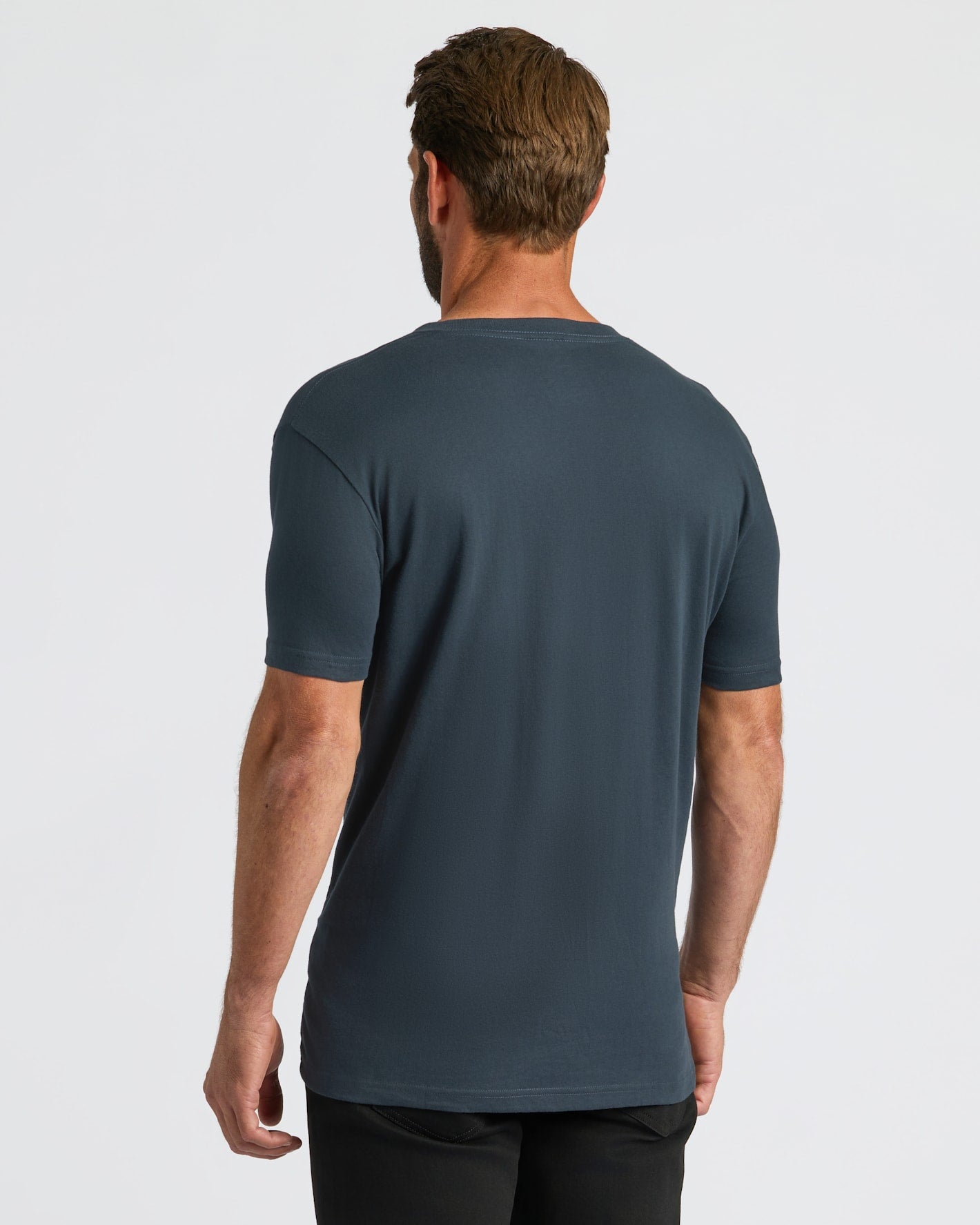 Man wearing a dark blue t-shirt on a white background