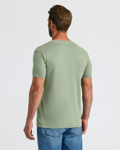 True ClassicMan wearing a green t-shirt and blue jeans on a white background