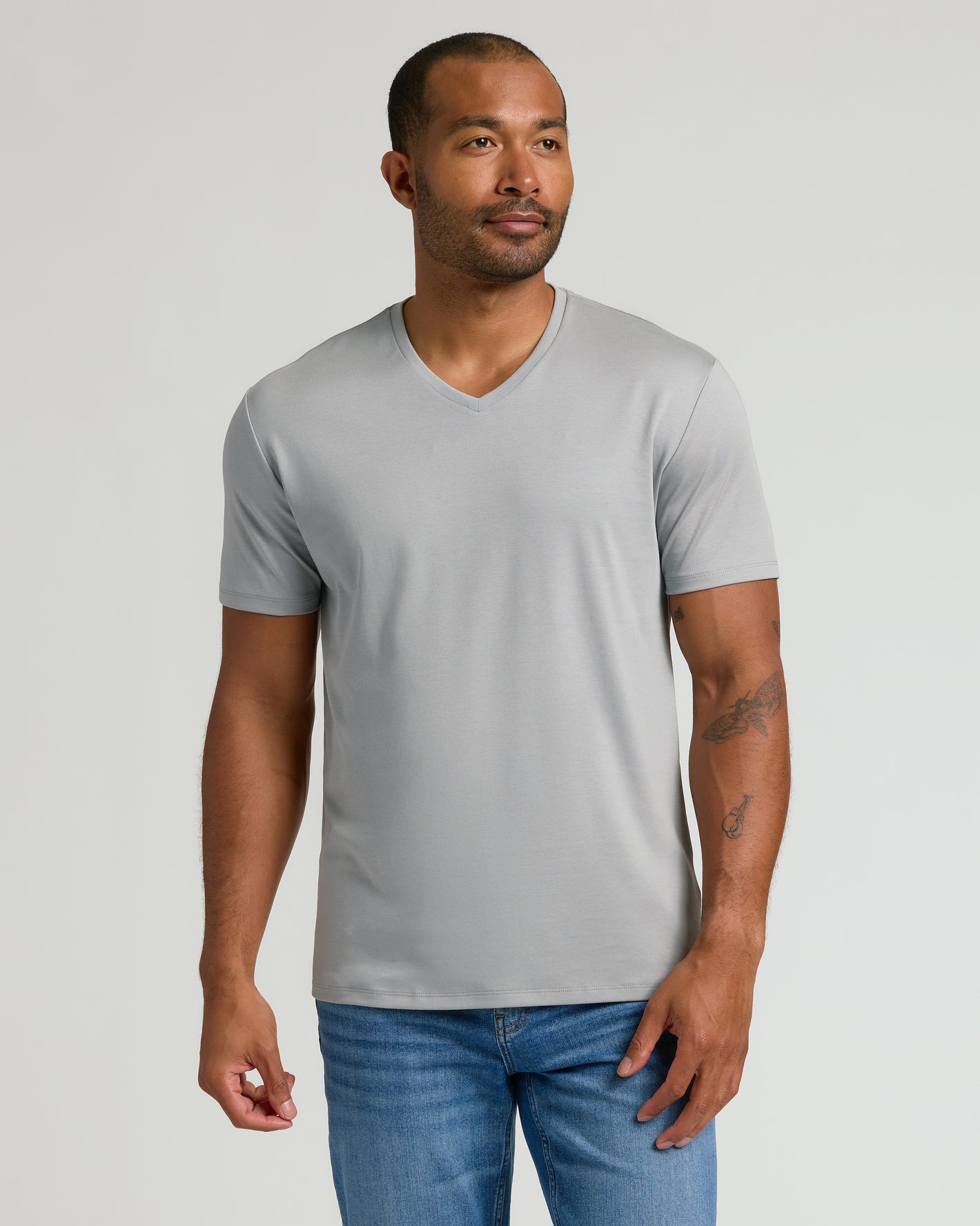 Steel Premium Pima V-Neck on model, showcasing tailored fit and forearm tattoos.