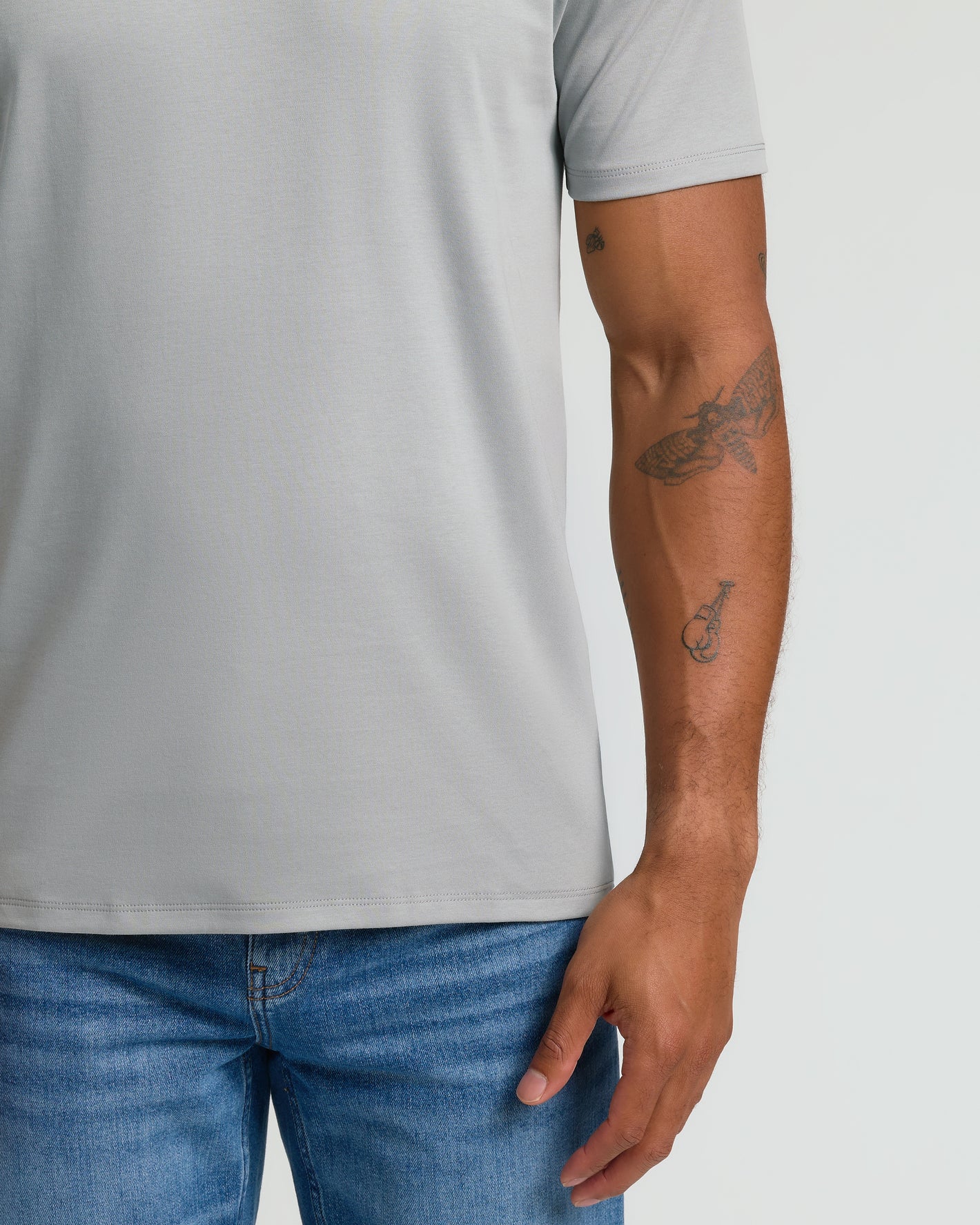 Steel White Pima V-Neck 2-Pack on tattooed arm. Premium fabric.