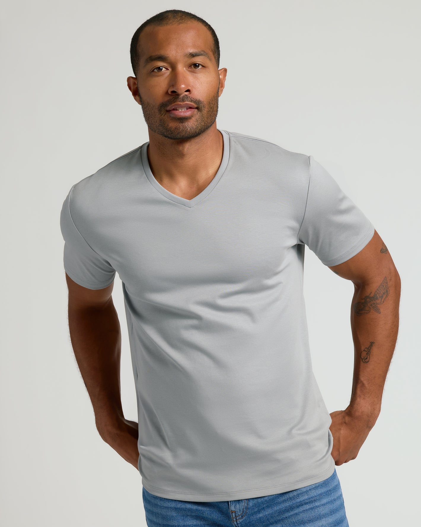 Man in Steel White Pima V-Neck, showcasing tailored fit.