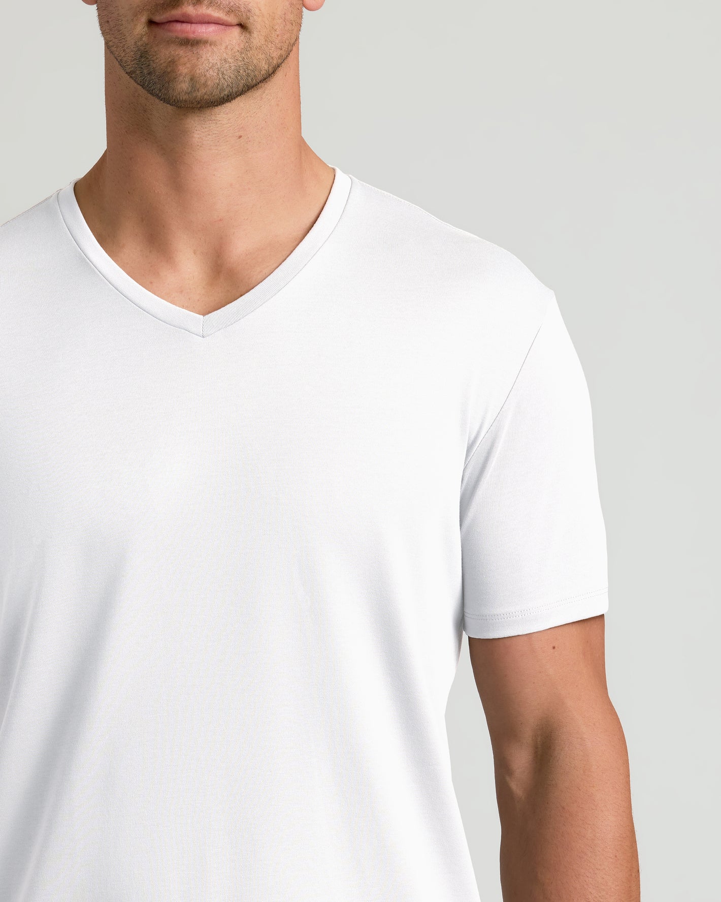 Man wearing Black & White Premium Pima V-Neck T-shirt, showcasing tailored fit.