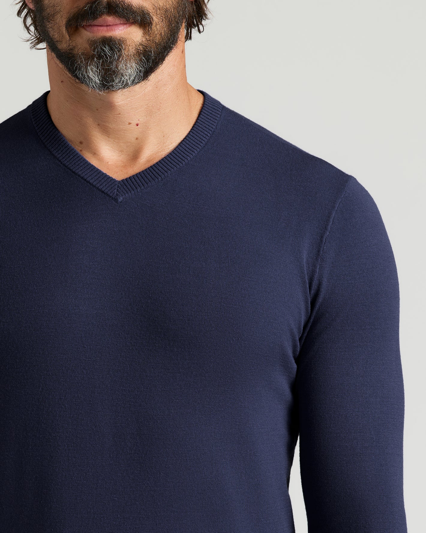 Staple Dressy V-Neck Sweater 3-Pack on a bearded man.