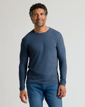 Man in Heather Navy Classic Long Sleeve Crew Neck and jeans.