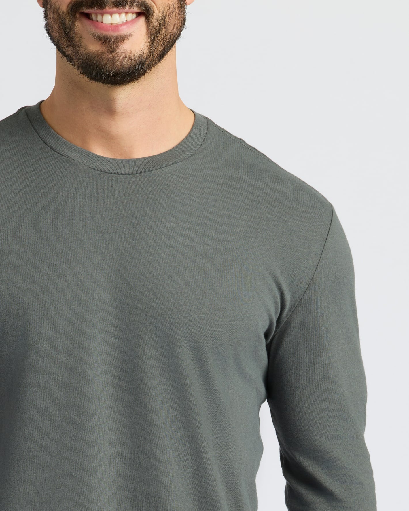 Person wearing Staple Classic Long Sleeve Crew Neck in olive green.