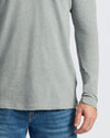 Gray long-sleeve shirt worn by a person on a white background
