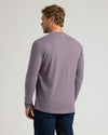 Man wearing Seasonal Classic Long Sleeve Henley, muted lavender, back view.