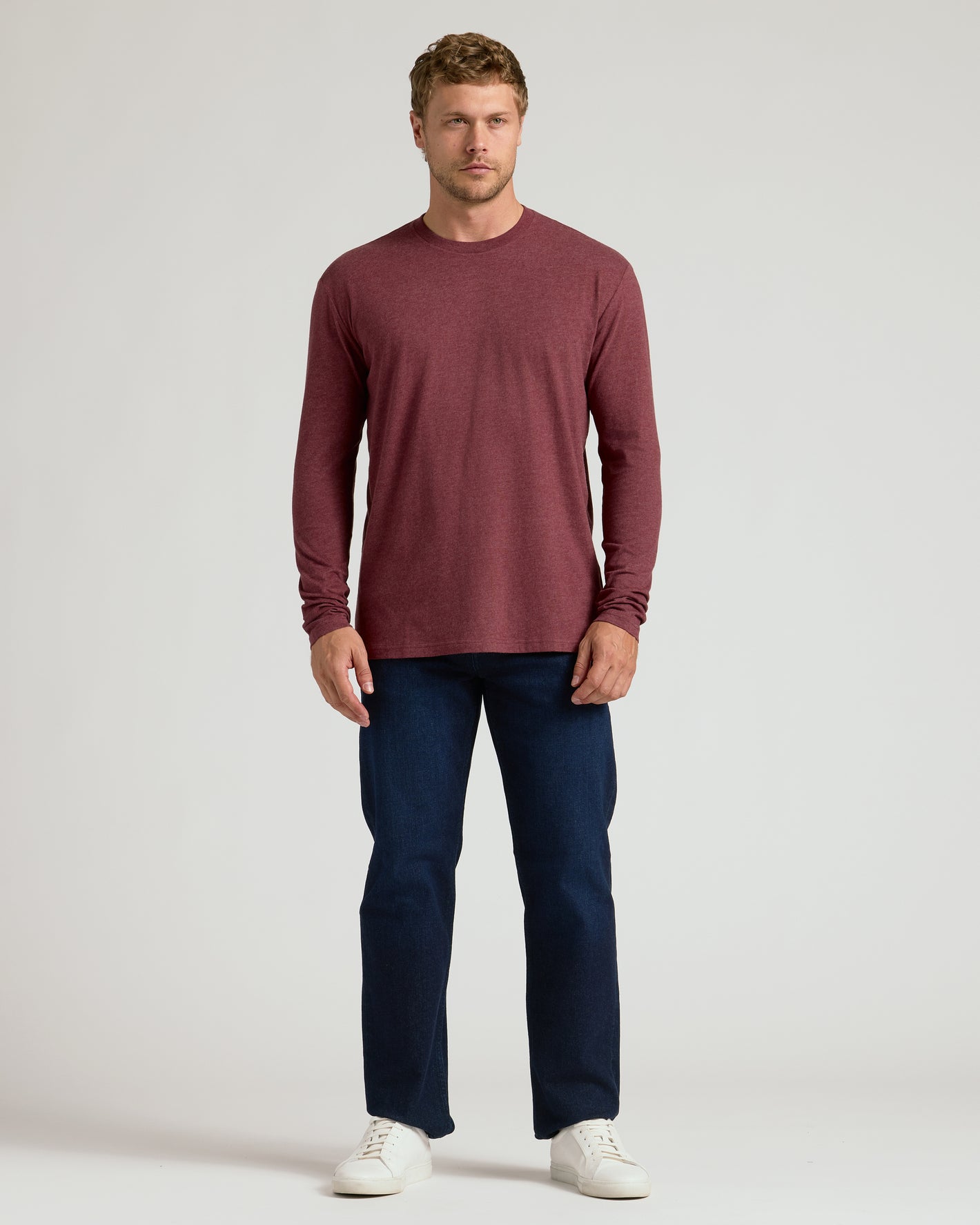 Man wearing Dark Heather Clovewood Classic Long Sleeve Crew Neck.