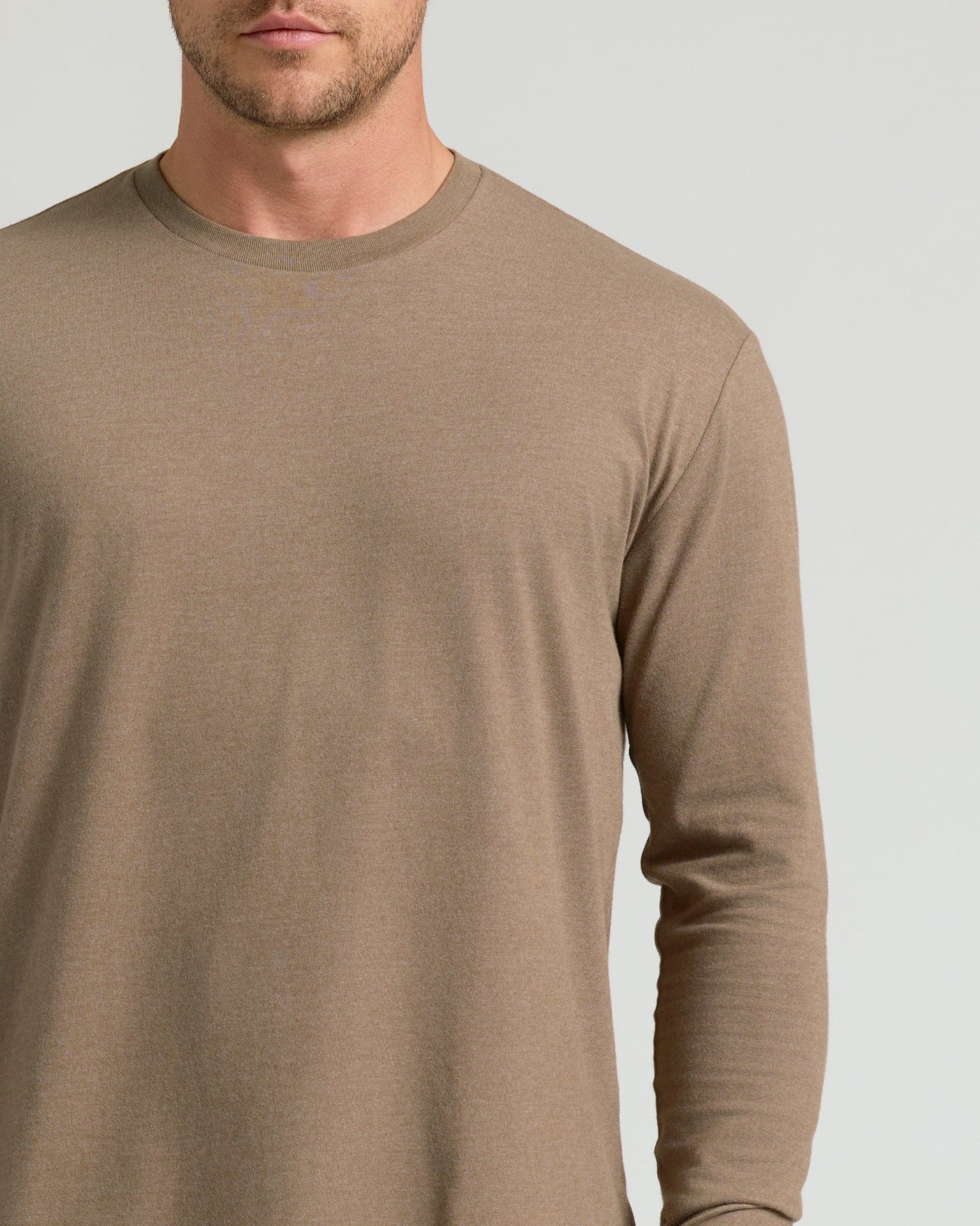 Man wearing Dark Heather Sagewood Classic Long Sleeve Crew Neck shirt.