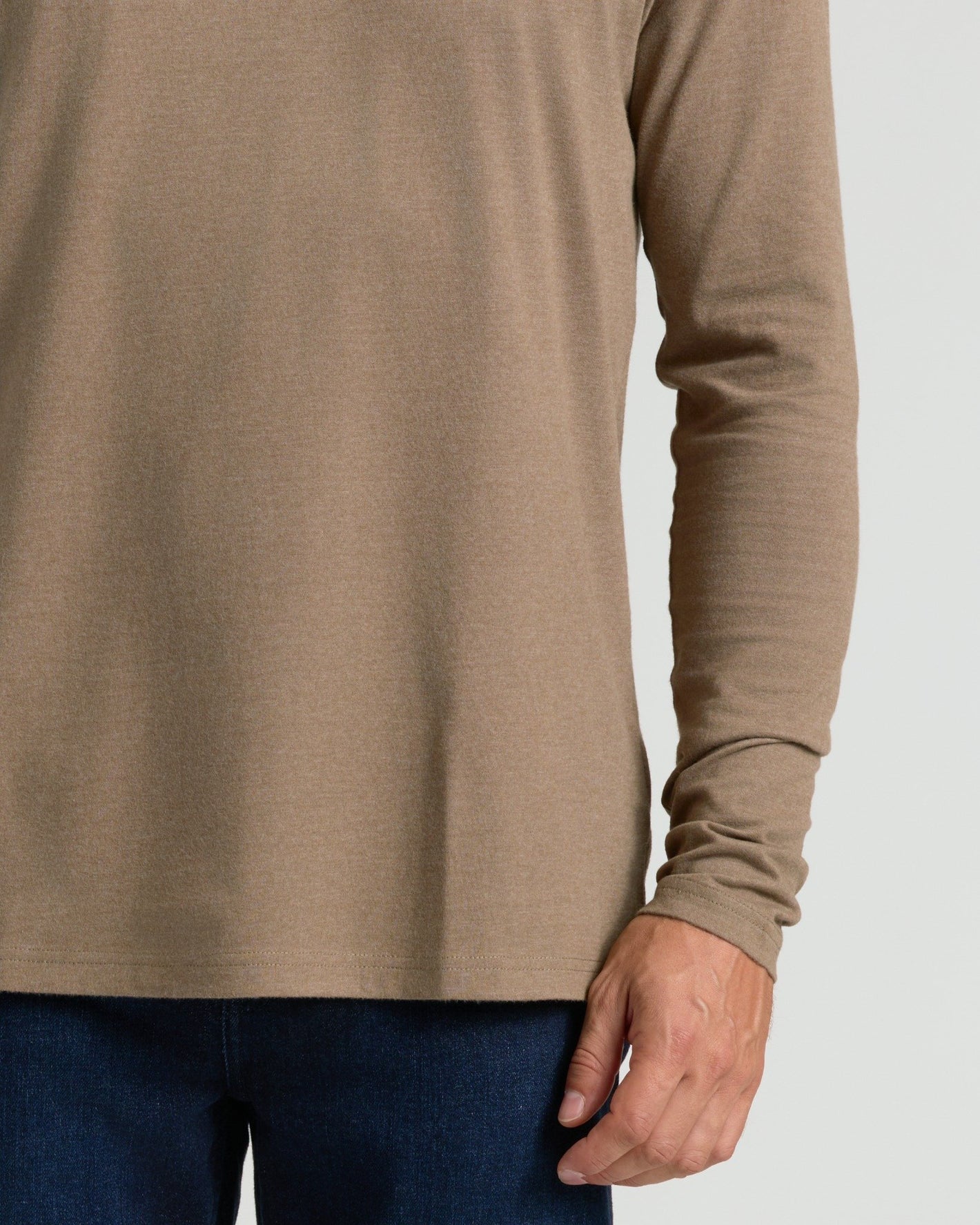 Dark Heather Sagewood Classic Long Sleeve Crew Neck with jeans, midsection view.