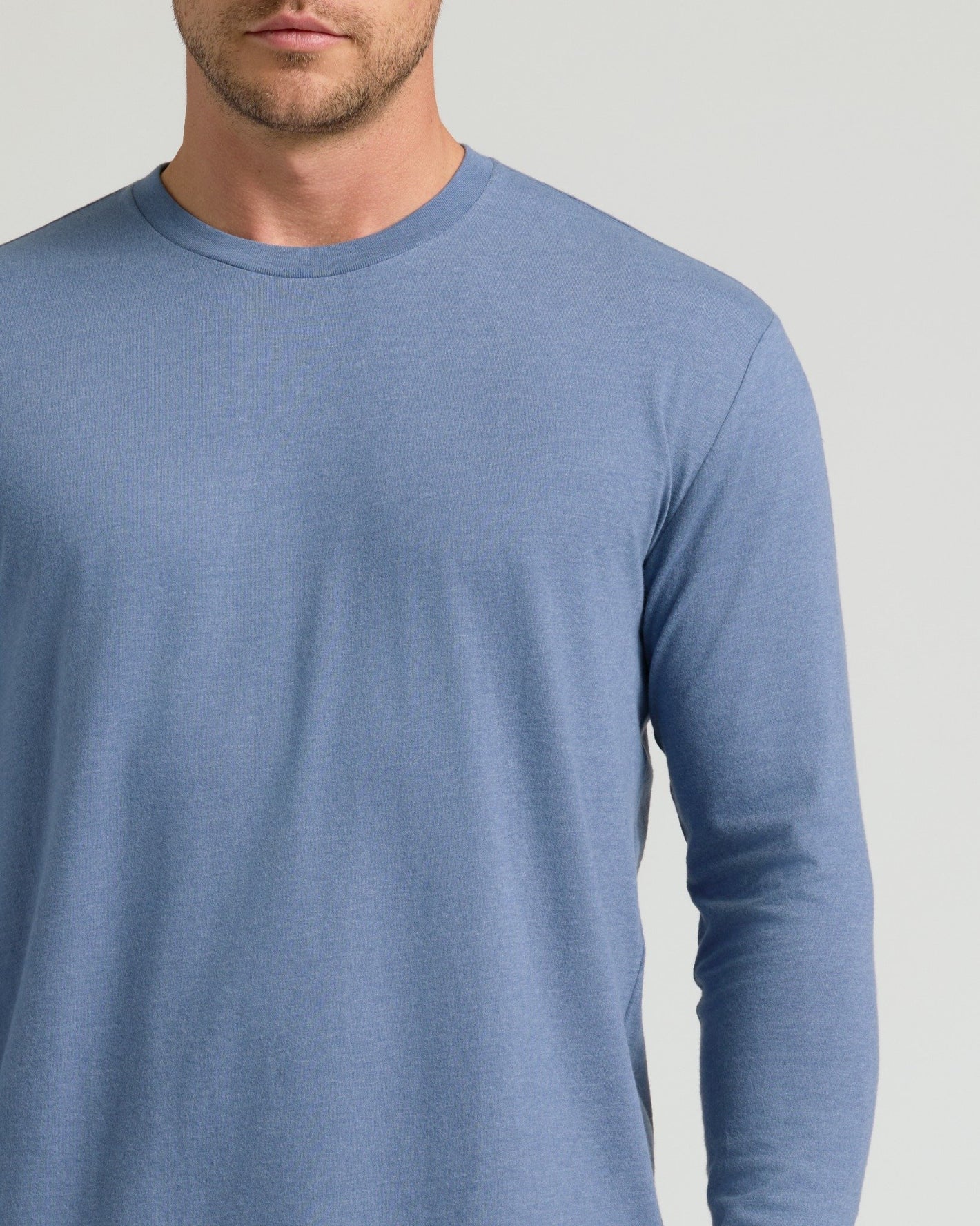 Man wearing Dark Heather Vintage Navy Classic Long Sleeve Crew Neck.