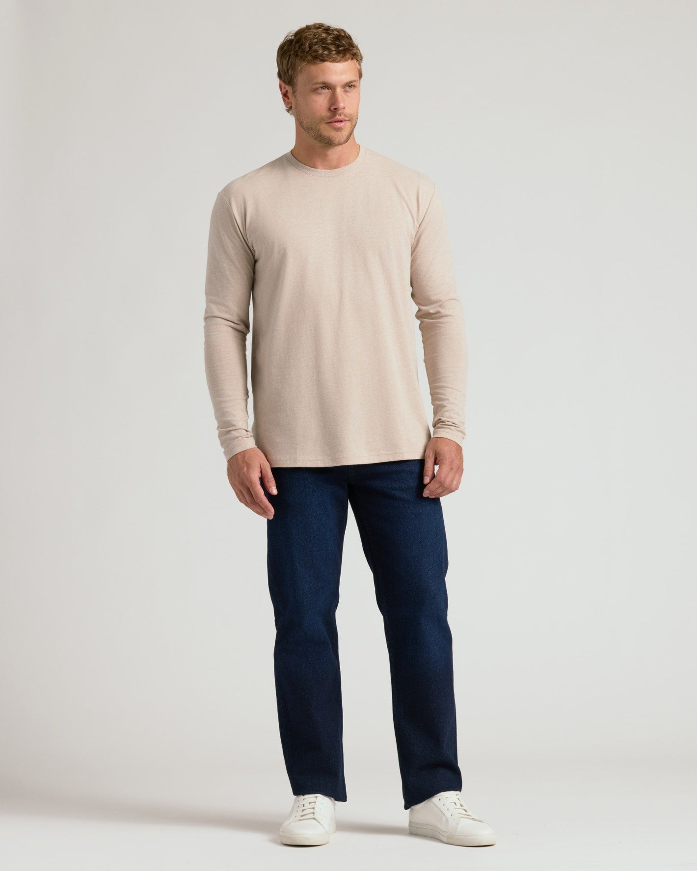 Man wearing Heather Truffle Classic Long Sleeve Crew Neck with jeans.