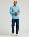 Man wears Heather Voyager Classic Long Sleeve Crew Neck with jeans.