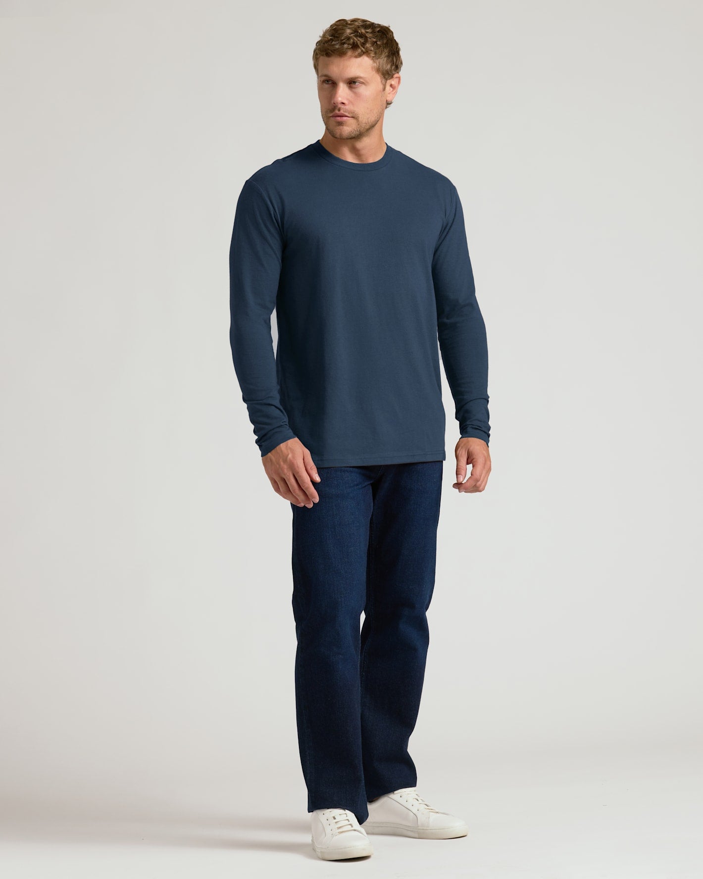 Classic Long Sleeve Crew Neck 10-Pack modeled in navy shirt and jeans.