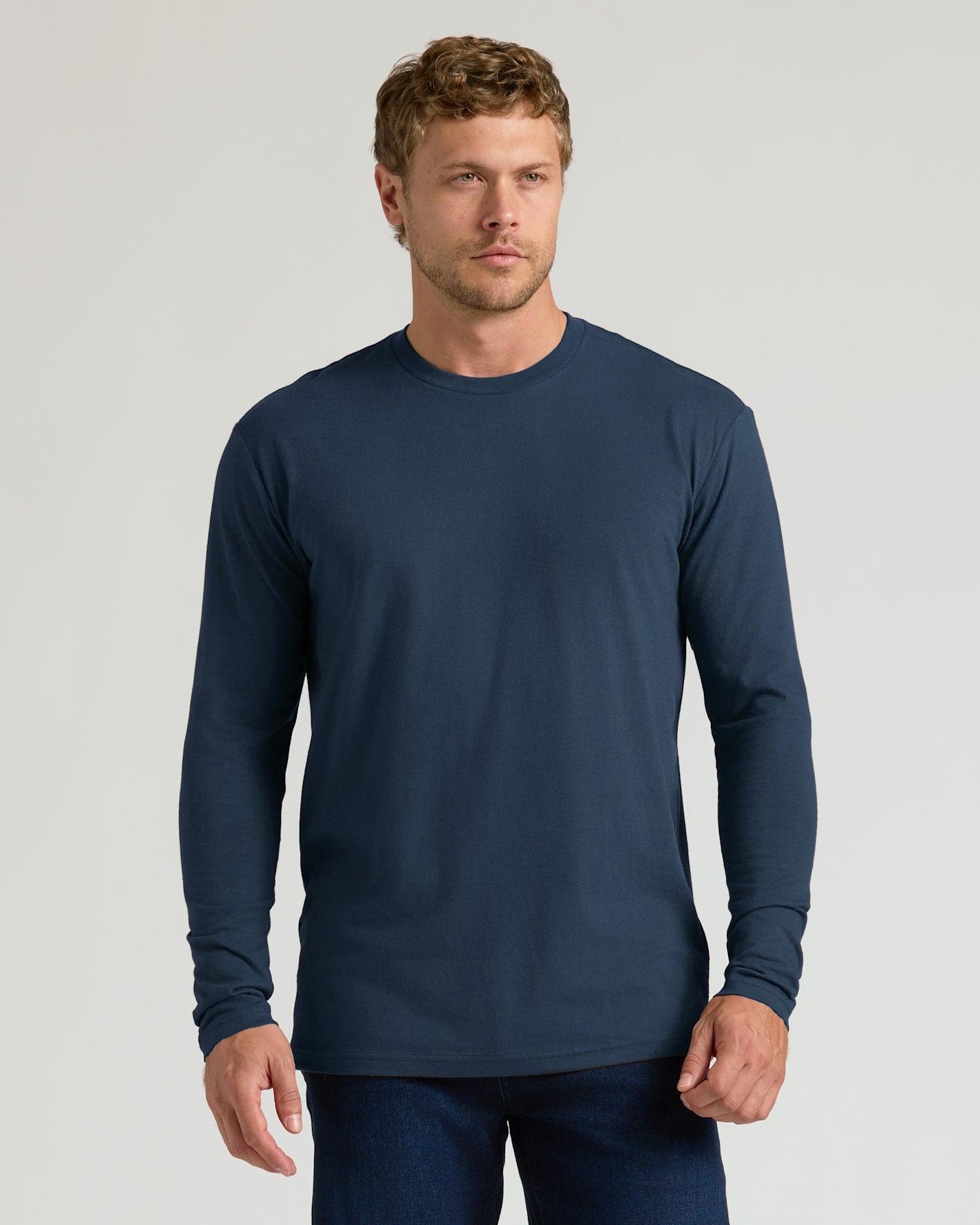 Model in navy Classic Long Sleeve Crew Neck, wearing dark jeans.